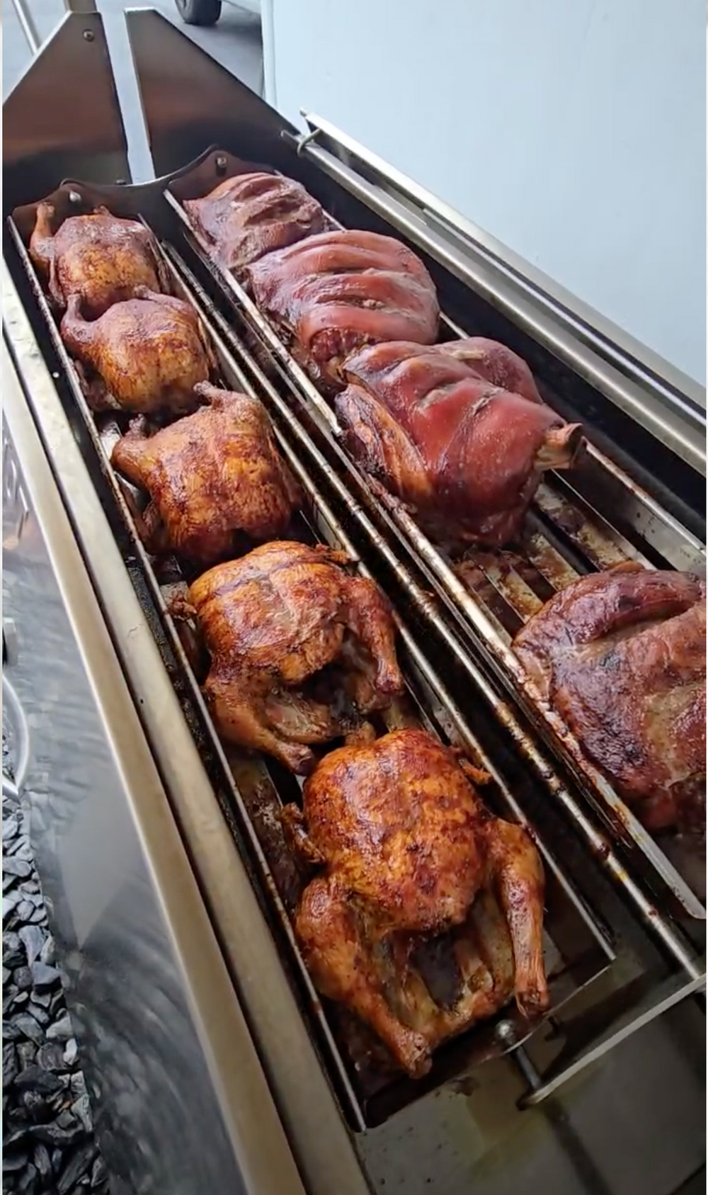 Chicken roasting on a rotisserie spit