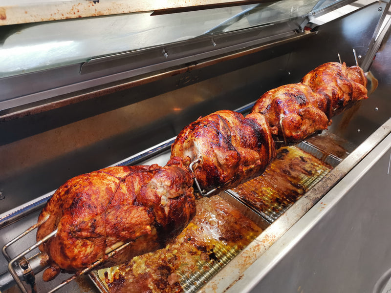 Roasting turkey on a rotisserie grill