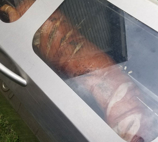 A raw pig inside of a pigout roaster